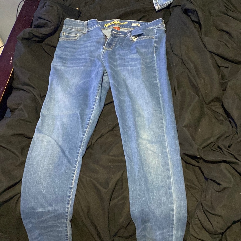 Blue jeans , size 11 womens , jeggins , distress on back pocket .
